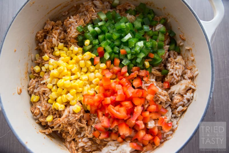 Chicken Taco Rice Salad // Want an easy weeknight meal that the whole family will love? Try this super family friendly flavor packed chicken dish on your next menu! Serve it atop Fritos corn chips, sprinkled with fresh cheddar cheese and you've got an out of this world dinner! One to be made again and again! | Tried and Tasty