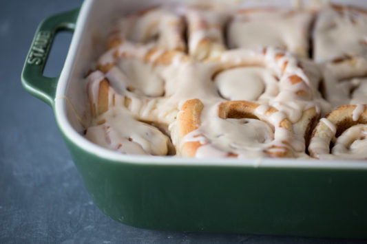 Close up shot of cinnamon rolls with maple icing