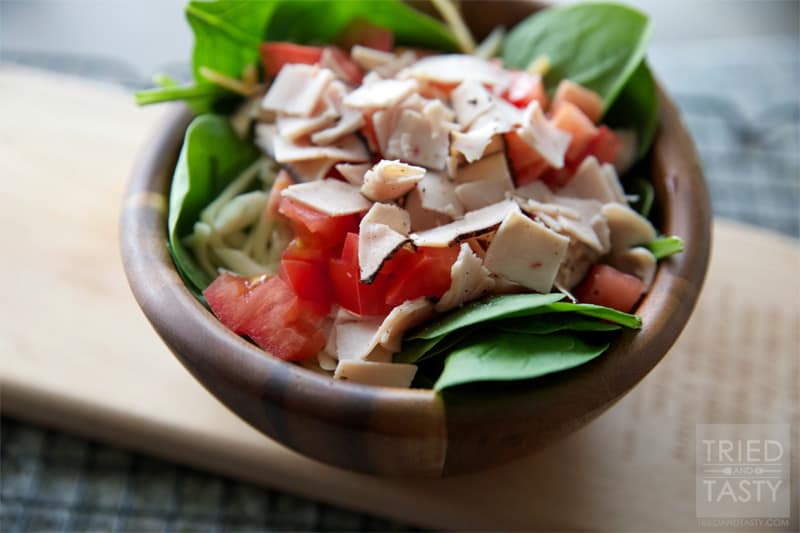 Turkey, Cheese & Tomato Spinach Salad // A quick & easy salad that is thrown together in no time! Sliced turkey breast is the star of the show, add in your favorite toppings and you've got a great lunch or side salad. | Tried and Tasty
