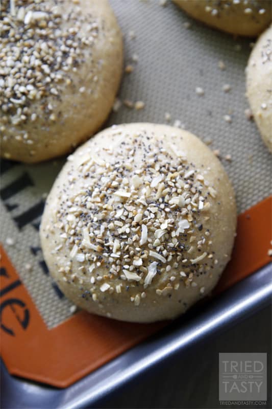Homemade Whole Wheat Everything Hamburger Buns // If you are familiar with the 'everything' bagel and love it, you will love this hamburger bun. If you aren't familiar with it, you have GOT to give this a try. The smell alone of these baking in the oven is enough to make your senses run wild! | Tried and Tasty
