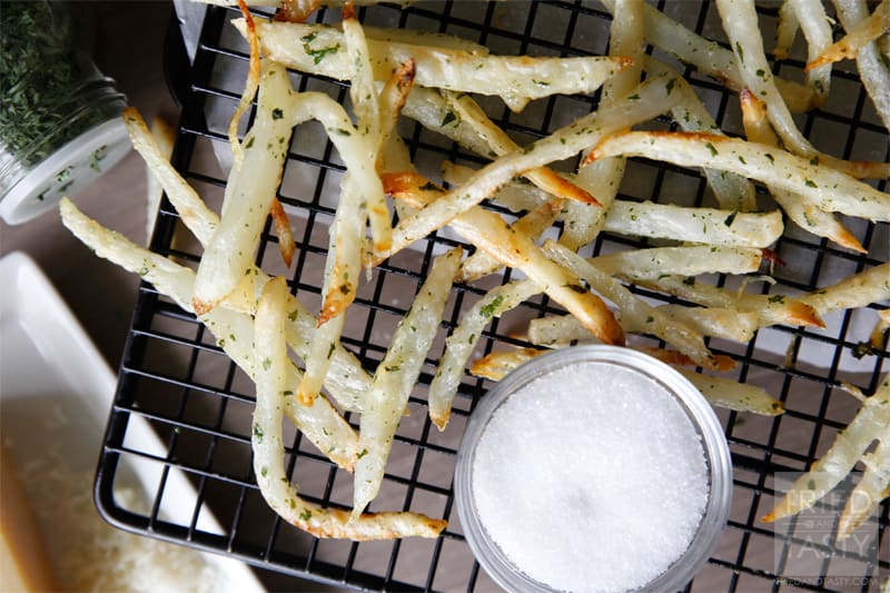 Double-Baked Crazy-Crisp Parmesan Oven Fries // A crispy fry that's oven baked for a healthier alternative to the traditional deep fried. Throw in some parmesan cheese and you've got the tastiest fries around! | Tried and Tasty