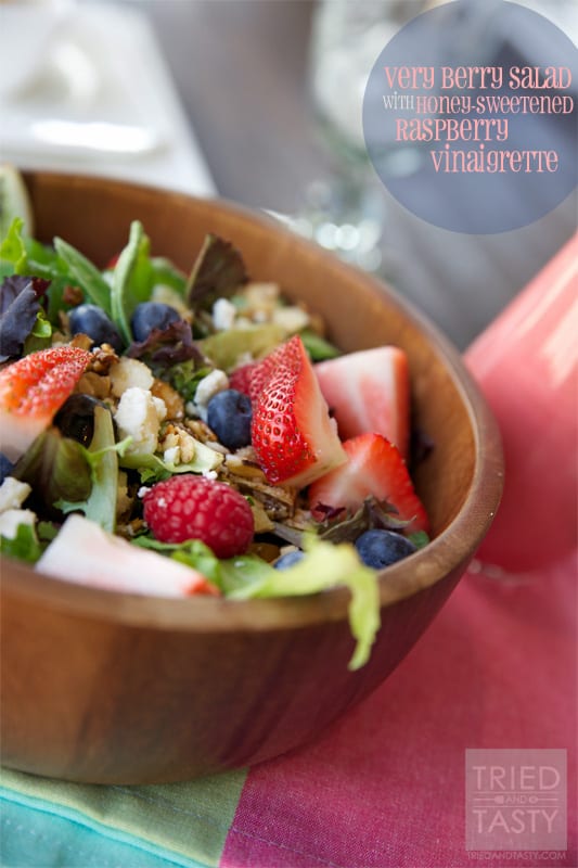 Very Berry Salad with Honey Sweetened Raspberry Vinaigrette // The perfect way to welcome summer. All of your favorite berries on top of a bed of greens sprinkled with feta cheese and candied almonds. Drizzled with a fantastic vinaigrette. | Tried and Tasty