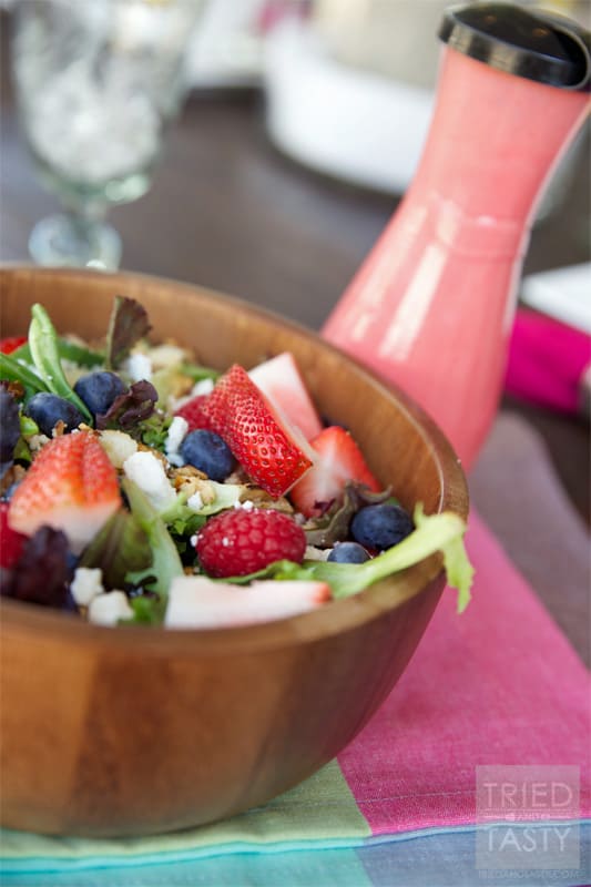 Very Berry Salad with Honey Sweetened Raspberry Vinaigrette // The perfect way to welcome summer. All of your favorite berries on top of a bed of greens sprinkled with feta cheese and candied almonds. Drizzled with a fantastic vinaigrette. | Tried and Tasty