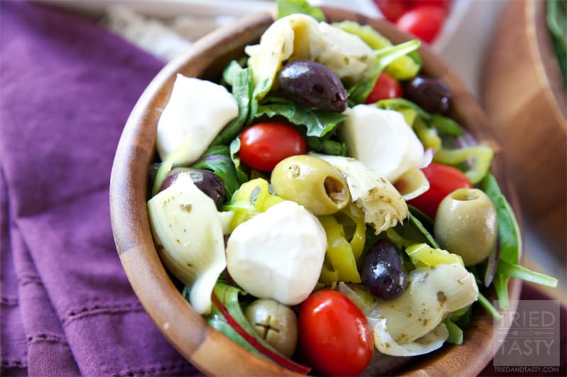 Mediterranean Salad With A Creamy Feta Dressing // The most wonderful Mediterranean Salad featuring the delicious flavors of marinated artichokes, fresh mozzarella, savory olives, and red onion. Finish it off with the most delectable creamy feta dressing for a knockout pairing! | Tried and Tasty
