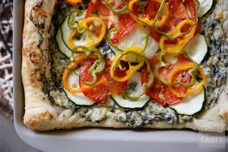 Spinach & Artichoke Veggie Pizza // A delicious way to use up some of your favorite seasonal vegetables. For the gardeners, you can grab most all of these veggies from your backyard. For the non-gardeners run to your nearest farmer's market & plan this pizza for your next get together! | Tried and Tasty