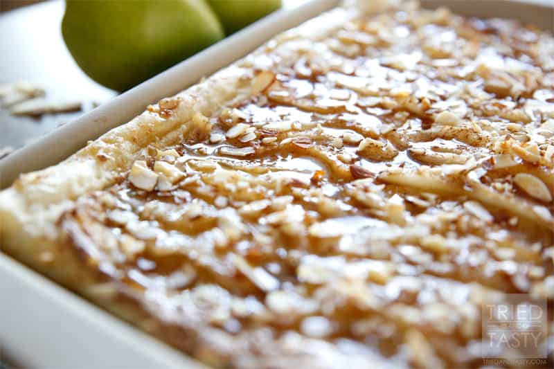 Honey Almond Poached Pear Tart // This Honey Almond Poached Pear Tart is a fancy dessert that looks like you've slaved hours in the kitchen over it. The best part about it? This gorgeous treat comes together with little effort. Your guests will be impressed and your belly will be satisfied! | Tried and Tasty