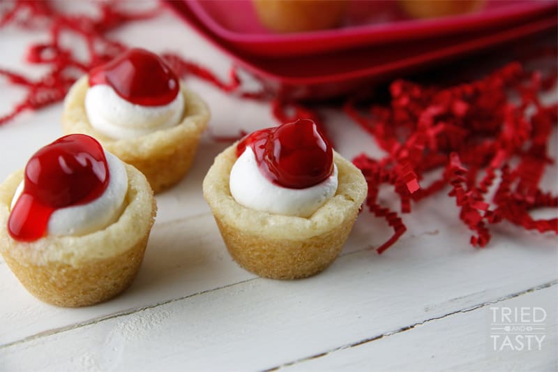 Mini Cherry Cheesecake Sugar Cookie Cups // These delicious little bite-sized bits of heaven are perfect for Valentine's Day! They are mini, fit right in the palm of your hand, and will be gobbled up in no time. With the tiniest hint of coconut, you'll be left wanting more! | Tried and Tasty
