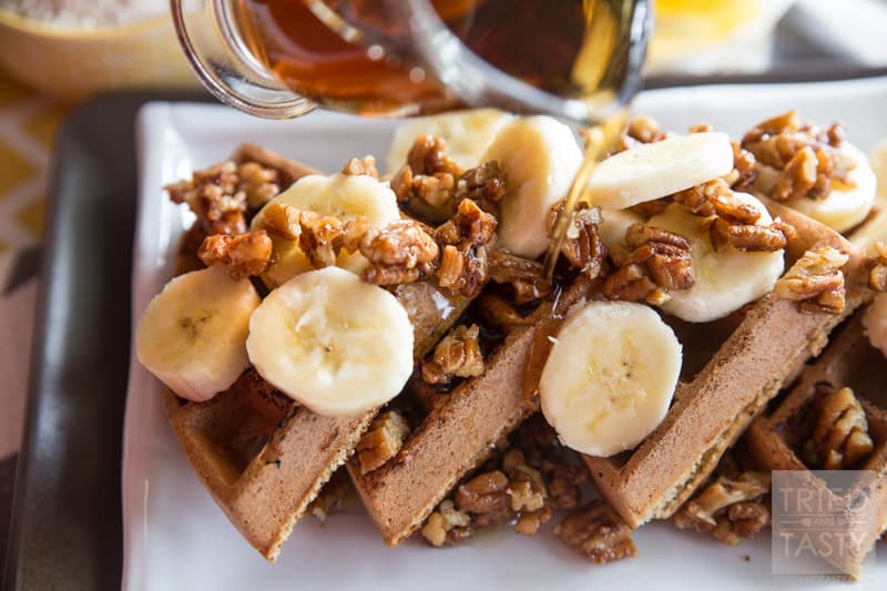 Gluten Free Banana Nut Waffles // These healthy & delicious waffles are the perfect way to start your morning. Made with oat flour, you can have your favorite waffles without any wheat! Topped with maple candied pecans and bananas, they are a treat you don't want to miss! | Tried and Tasty