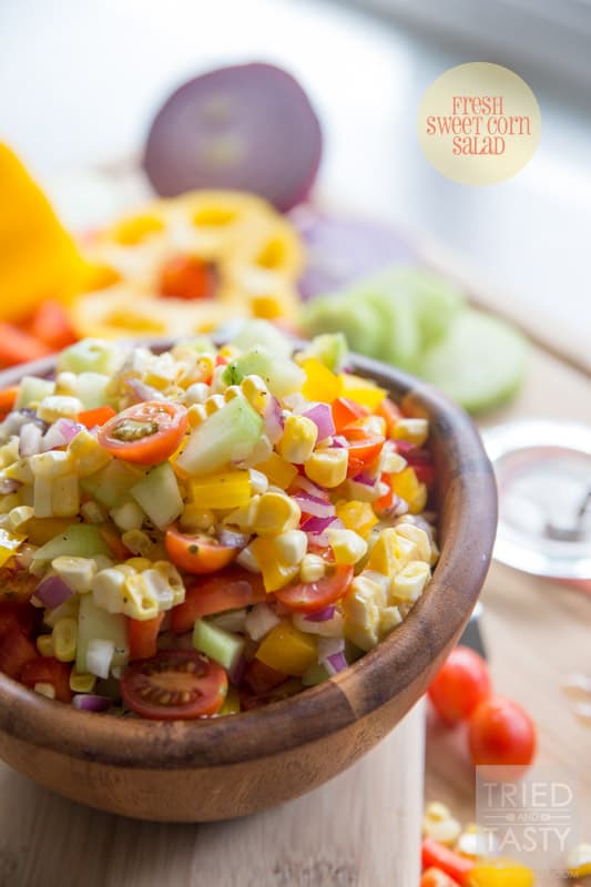 Fresh Sweet Corn Salad // Nothing screams summer like fresh corn! Am I right? I love fresh sweet corn all kinds of different ways, but I especially love it in this yummy salad. Jam packed with all kinds of bright fun veggies, coated in a tangy refined sugar-free dressing! Perfect for any potluck, BBQ, or picnic. | Tried and Tasty