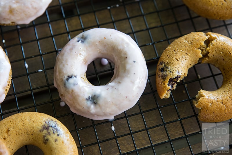 Baked Gluten Free Lemon Blueberry Doughnuts // If you are a doughnut lover but don't want all of the extra calories and sugar, give these baked doughnuts a try. With a little bit of citrus paired with plump & juicy blueberries - these are perfect for breakfast or dessert! | Tried and Tasty