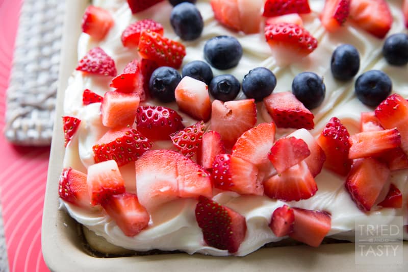 Berries 'n Cream Cheese Cake // Looking for a light, delicious, and EASY treat to feed a crowd? This sheet cake is perfect for parties, family gatherings, BBQ's and potlucks! You'll be amazed at how simple it is to put together! | Tried and Tasty