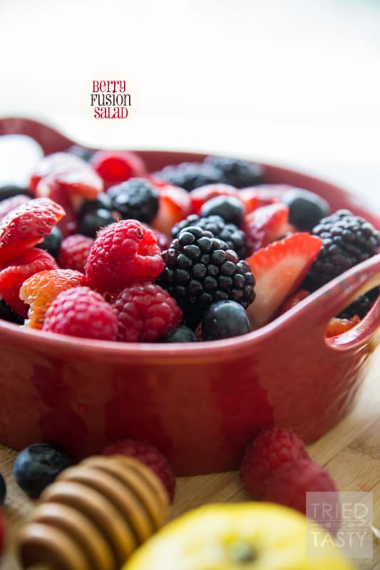 Berry Fusion Salad // Often times you find that a berry salad is loaded with a syrup made with granulated white sugar. The fruit is already sweet as it is, why not add a more simple all-natural syrup to give it the extra hint of sweetness that is needs? This Berry Fusion Salad is perfect for your potluck, bbq, party, or gathering. Made without any refined sugar - you can feel good about taking that extra scoop! | Tried and Tasty 