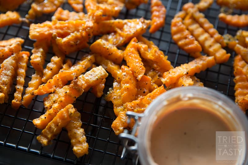 Crinkle Cut Sweet Potato Fries // Why buy storebought sweet potato fries when you can make your own? These are just like what you'd find at the store but only better! With just a few ingredients, these would be the perfect side dish for any grilled hamburgers or hot dogs at your next BBQ! | Tried and Tasty