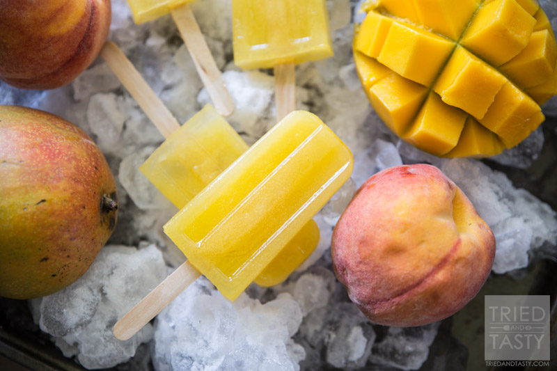 Mango Peach Lemonade Popsicles // Looking for a delicious sweet 'n tart frozen treat? Look no further, this is the popsicle for you! Made with no refined sugar - these are perfect for the whole family! | Tried and Tasty