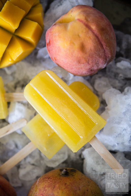 Mango Peach Lemonade Popsicles // Looking for a delicious sweet 'n tart frozen treat? Look no further, this is the popsicle for you! Made with no refined sugar - these are perfect for the whole family! | Tried and Tasty