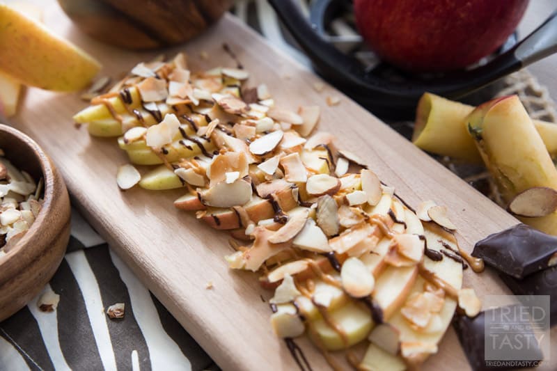 Chocolate Peanut Butter Apples with Coconut and Almonds // Want a sweet treat but not all the calories that typically come with them? These quick & easy apples are perfect! Just the right touch of sweetness to curb your sweet tooth while still being health conscious! | Tried and Tasty