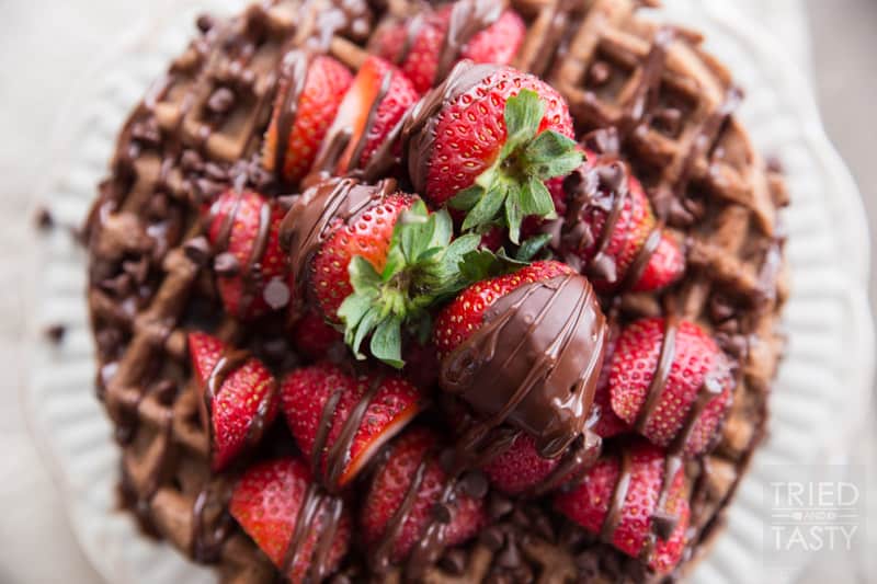 Whole Wheat Dark Chocolate Covered Strawberry Waffles // Looking for a fun new way to enjoy breakfast? Try these delicious chocolate waffles. The best part about them? They are actually not bad for you! You'll be surprised that they are made with whole wheat flour and no refined sugar! Drizzled with dark chocolate and covered with fresh strawberries. A beautiful way to start your morning! | Tried and Tasty