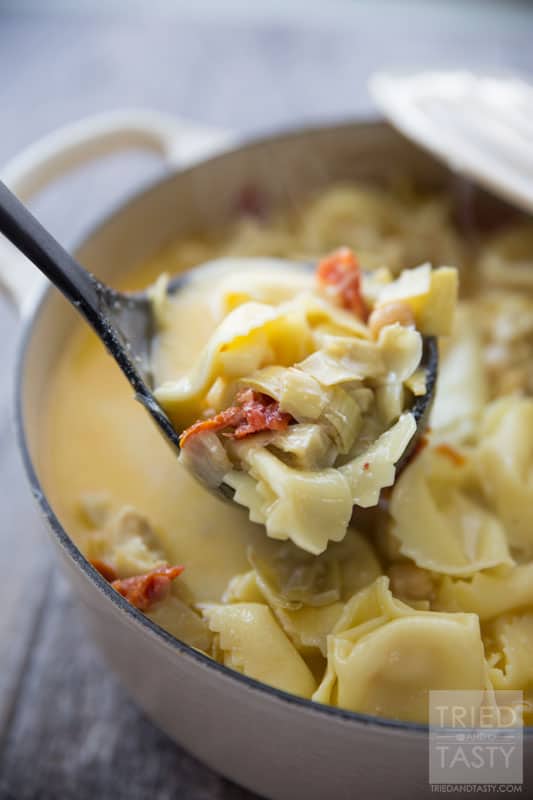 Tortellini & Artichoke Soup // This simple soup is both filling and suprisingly a healthy comfort food. You'll never believe the secret ingredient helping make it 'lighter'. Enjoy this warm bowl of goodness to heat you from the inside out! | Tried and Tasty