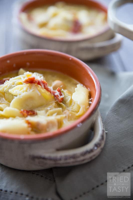 Tortellini & Artichoke Soup // This simple soup is both filling and surprisingly a healthy comfort food. You'll never believe the secret ingredient helping make it 'lighter'. Enjoy this warm bowl of goodness to heat you from the inside out! | Tried and Tasty