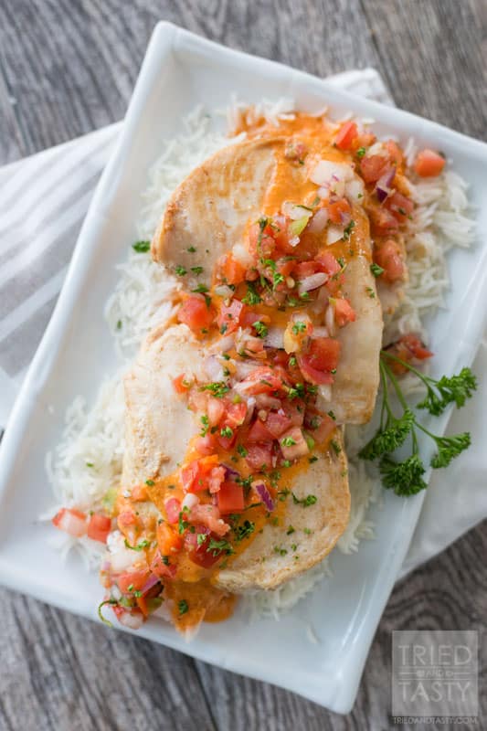 Bruschetta Chicken // Looking for a delicious diner idea for that someone special in your life? This chicken is super easy to whip together and wonderfully tasty. Plus, check out a few other great recipes that will pair nicely to make an entire romantic dinner! | Tried and Tasty