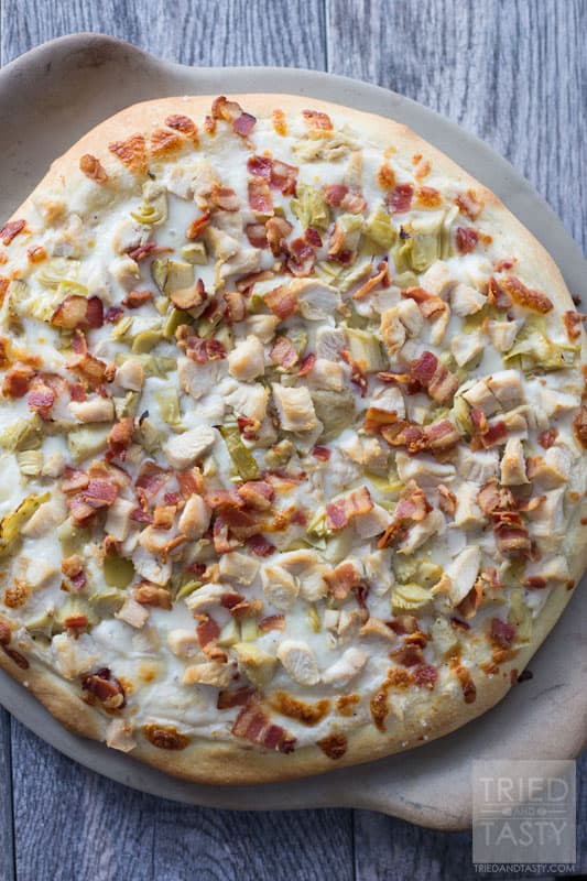 Chicken Bacon Artichoke Alfredo Pizza // One of the best pizza combinations out there. Super simple to throw together, but packed with great flavor. Prepare a delicious crust and top with the best of the best. This pizza makes for a great lunch or dinner - and even delicious as leftovers! | Tried and Tasty