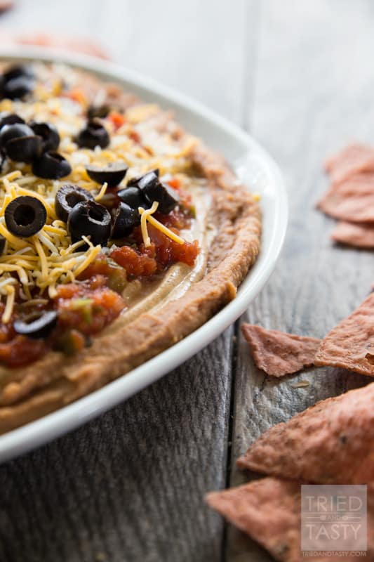 Five Layer Bean Dip // How do you celebrate Taco Tuesday? Cinco de Mayo? Or any other occasion you may be enjoying a Mexican fiesta? May I suggest this delicious bean dip. Not your typical 'seven layer', it's BETTER! Serve with your favorite chips at your next party or get together! | Tried and Tasty