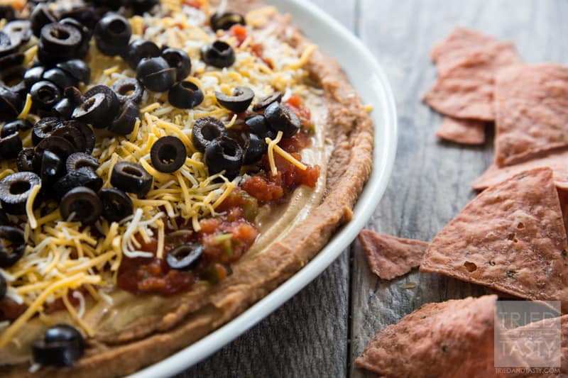 Five Layer Bean Dip // How do you celebrate Taco Tuesday? Cinco de Mayo? Or any other occasion you may be enjoying a Mexican fiesta? May I suggest this delicious bean dip. Not your typical 'seven layer', it's BETTER! Serve with your favorite chips at your next party or get together! | Tried and Tasty