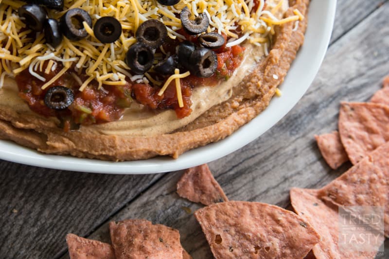 Five Layer Bean Dip // How do you celebrate Taco Tuesday? Cino de Mayo? Or any other occasion you may be enjoying a Mexican fiesta? May I suggest this delicious bean dip. Not your typical 'seven layer', it's BETTER! Serve with your favorite chips at your next party or get together! | Tried and Tasty