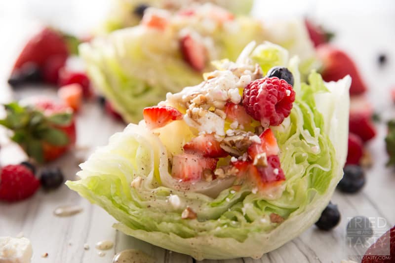 Mixed Berry Wedge Salad // Seve this at your next BBQ! You only need a handful of ingredients including: fresh lettuce, in-season berries, dressing and cheese. The crowd will go nuts with the stunning side dish! | Tried and Tasty