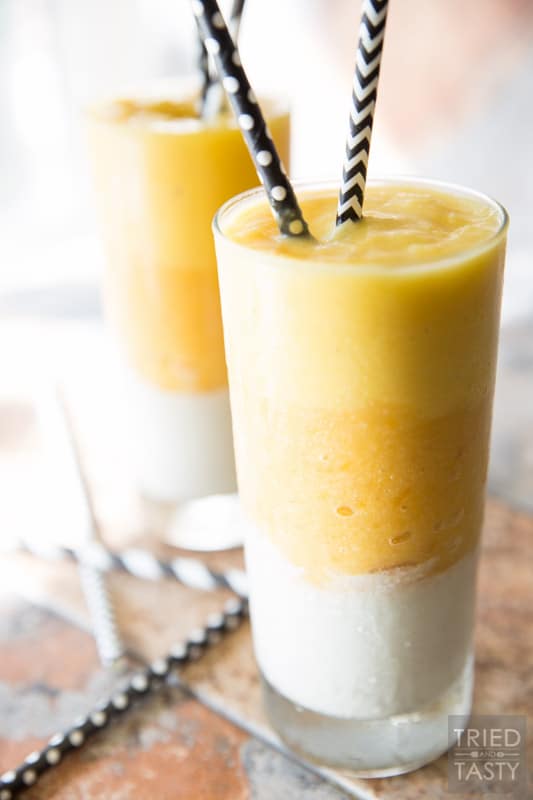 Candy Corn Layered Smoothie // Halloween treats are often associated with lots and lots of sugar BUT they don't have to be! This smoothie is made with real fruit, no added sugar, and the perfect sippable for any spooky night of the week in October! Make this healthy candy corn inspired smoothie for the kids AND adults! | Tried and Tasty