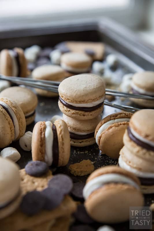 S'mores French Macarons // Whether it's National S'mores Day or not, these french macarons are the PERFECT way to celebrate anytime! With a tasty graham macaron, marshmallow buttercream, and chocolate ganache - these little babies will be devoured by everyone! | Tried and Tasty