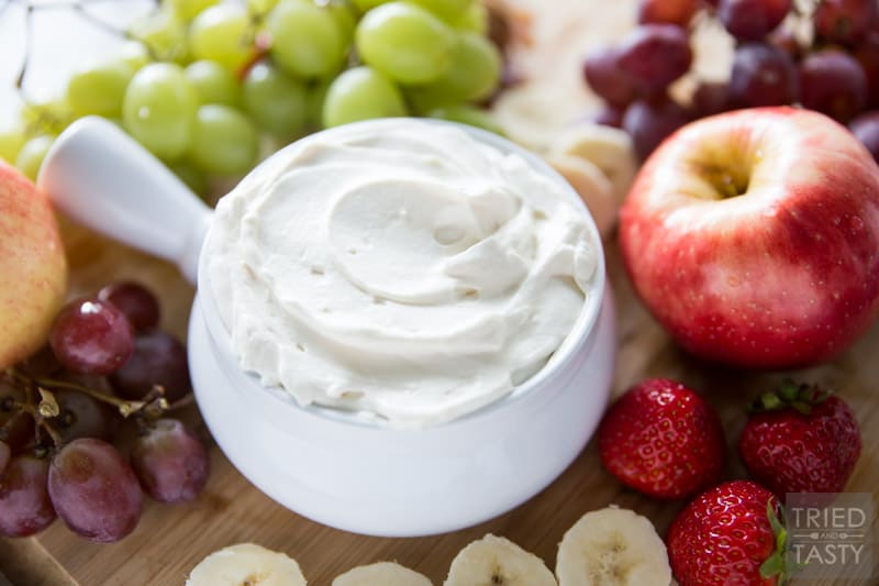 Honey Sweetened- Fruit Dip // Fruit is already sweet, so you don't need a sugar loaded dip to dunk it in. This fruit dip is absolutely perfect. It's light. It's fluffy. And it's *just* sweet enough, and sweetened all naturally with honey! Serve this at your next potluck or party and everyone will want the recipe! | Tried and Tasty