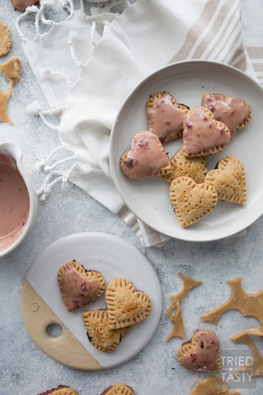 Homemade Sweet Cherry Mini Poptarts // Be still my heart! Have you seen a more adorable Poptart? These mini Poptarts are equally delicious. Made with whole wheat, cherry preserves and a scrumptious cherry glaze (optional)! | Tried and Tasty