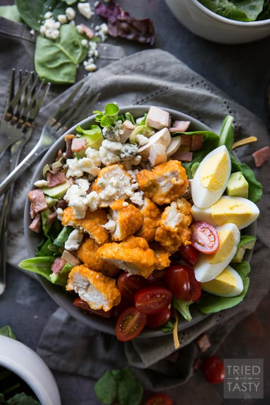 Buffalo Chicken Cobb Salad // Eating 'lighter fare' doesn't have to be tasteless and boring - I'm proving that to you with this delicious flavor packed salad! Comes together super easily and will keep you full through lunchtime and beyond. Take your Cobb salad to the next level, I promise you won't be sorry! | Tried and Tasty