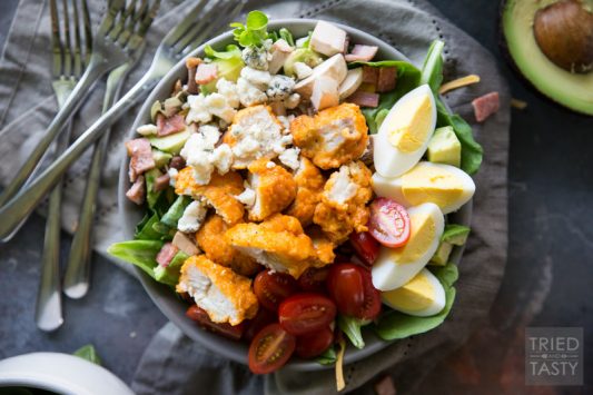 Buffalo Chicken Cobb Salad // Eating 'lighter fare' doesn't have to be tasteless and boring - I'm proving that to you with this delicious flavor packed salad! Comes together super easily and will keep you full through lunchtime and beyond. Take your cobb salad to the next level, I promise you won't be sorry! | Tried and Tasty