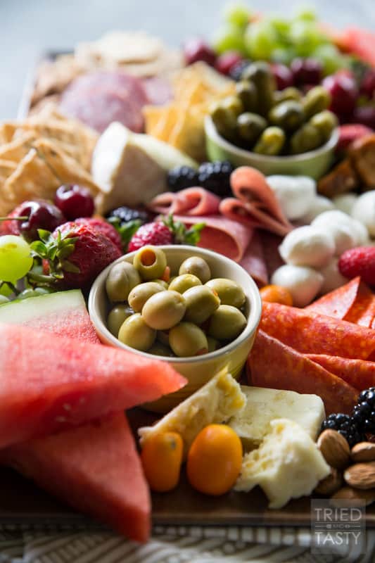 Fruit Lovers Summer Charcuterie // This taste of summer will wow your palate with all your favorite berries, cheeses, meats, and crackers. This is the perfect recipe for entertaining guests this summer! | Tried and Tasty.