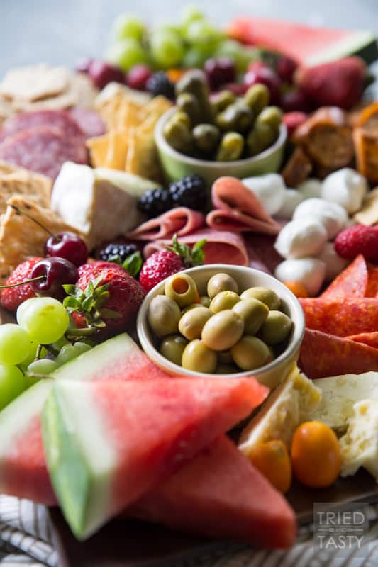 Fruit Lovers Summer Charcuterie // This taste of summer will wow your palate with all your favorite berries, cheeses, meats, and crackers. This is the perfect recipe for entertaining guests this summer! | Tried and Tasty.