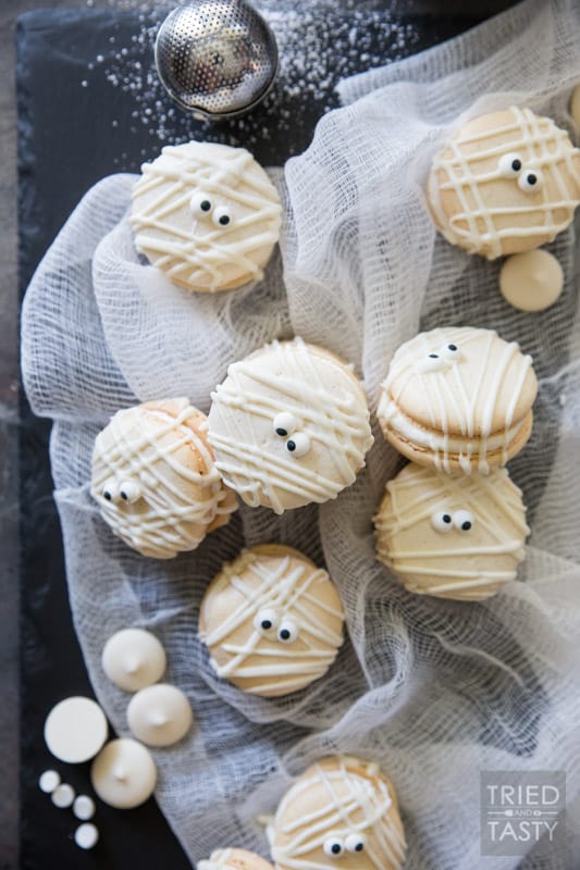 Mummy Macs {Vanilla Bean French Macarons} // Be the hit of your holiday party with these adorable mummy French macarons. Made with a classic vanilla bean cookie sandwiched together by the most delicious light & fluffy vanilla bean buttercream frosting! | Tried and Tasty
