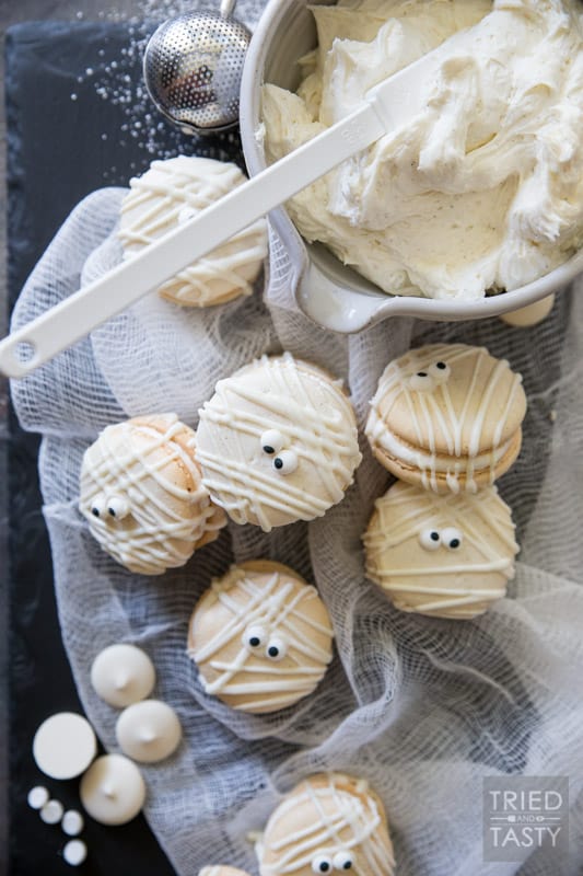 Mummy Macs {Vanilla Bean French Macarons} // Be the hit of your holiday party with these adorable mummy French macarons. Made with a classic vanilla bean cookie sandwiched together by the most delicious light & fluffy vanilla bean buttercream frosting! | Tried and Tasty