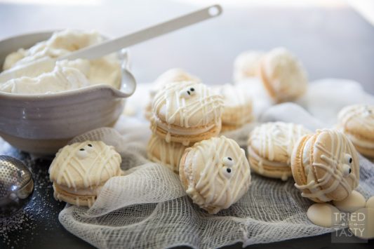 Mummy Macs {Vanilla Bean French Macarons} // Be the hit of your holiday party with these adorable mummy french macarons. Made with a classic vanilla bean cookie sandwiched together by the most delicious light & fluffy vanilla bean buttercream frosting! | Tried and Tasty