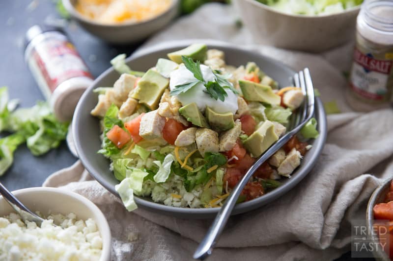 Skinny Burrito Bowl | This just might be the healthiest, most guilt free burrito bowl that you’ve ever seen! It’s built on a fluffy bed of cauliflower rice and topped with traditional favorites like cheese and diced avocado. | Tried and Tasty
