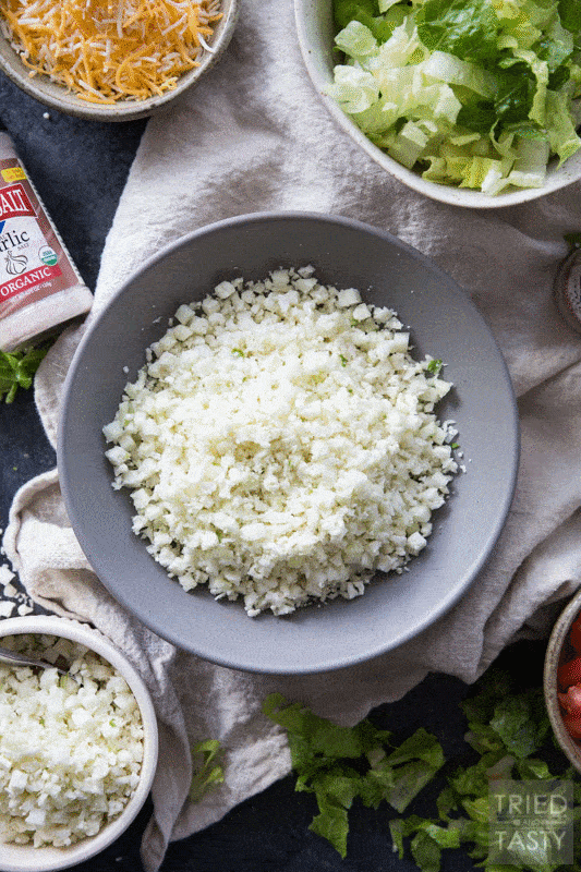 Skinny Burrito Bowl | This just might be the healthiest, most guilt free burrito bowl that you’ve ever seen! It’s built on a fluffy bed of cauliflower rice and topped with traditional favorites like cheese and diced avocado. | Tried and Tasty