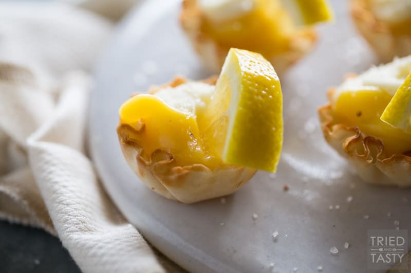 Salted Lemon Tartlets // If you want a sweet ending to a delicious meal without going overboard these bite-sized lemony treats are just what you've been looking for! Super simple to make, the perfect amount of zing & a secret twist of perfect saltiness! | Tried and Tasty