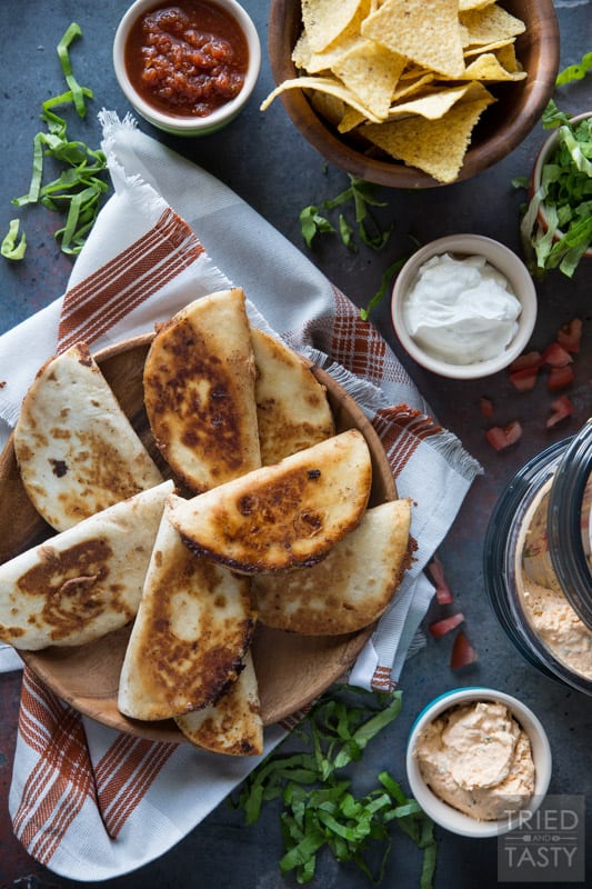 Mini Bean and Three-Cheese Quesadillas // The perfect summertime finger food that's not only delicious but equally portable. Packed full of cheesy flavor you'll fall in love at first bite! | Tried and Tasty