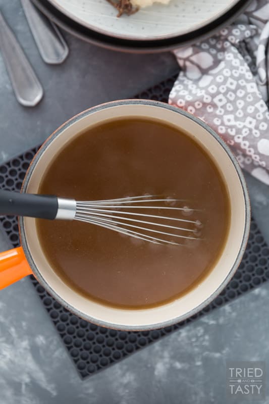 Saucepan of gravy with a whisk